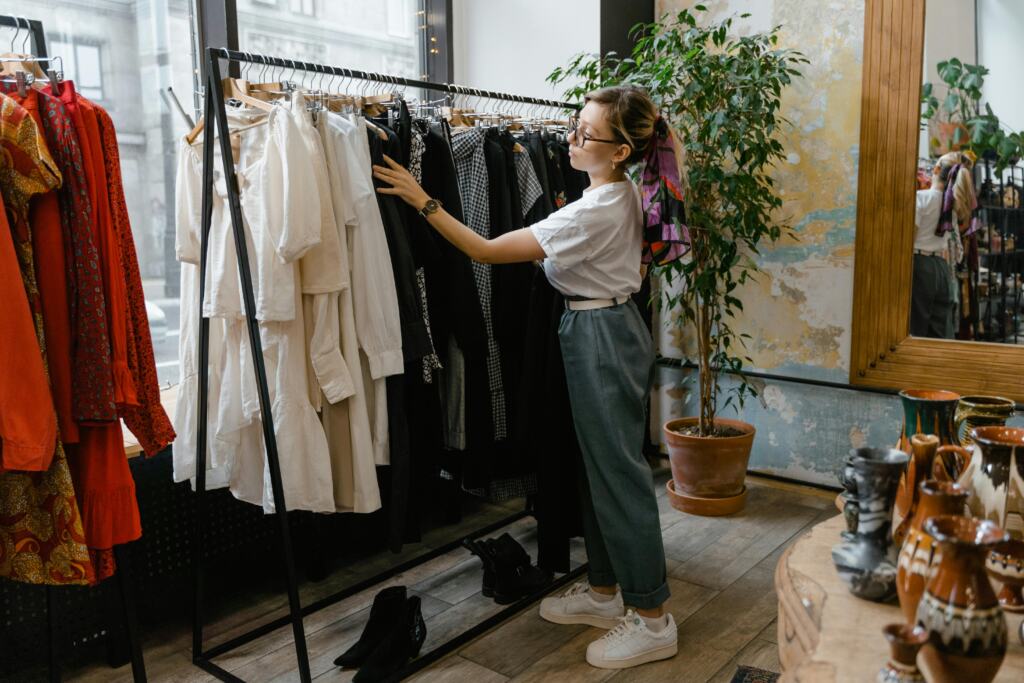 Women organizing clothes rack at Tallahassee Boutique