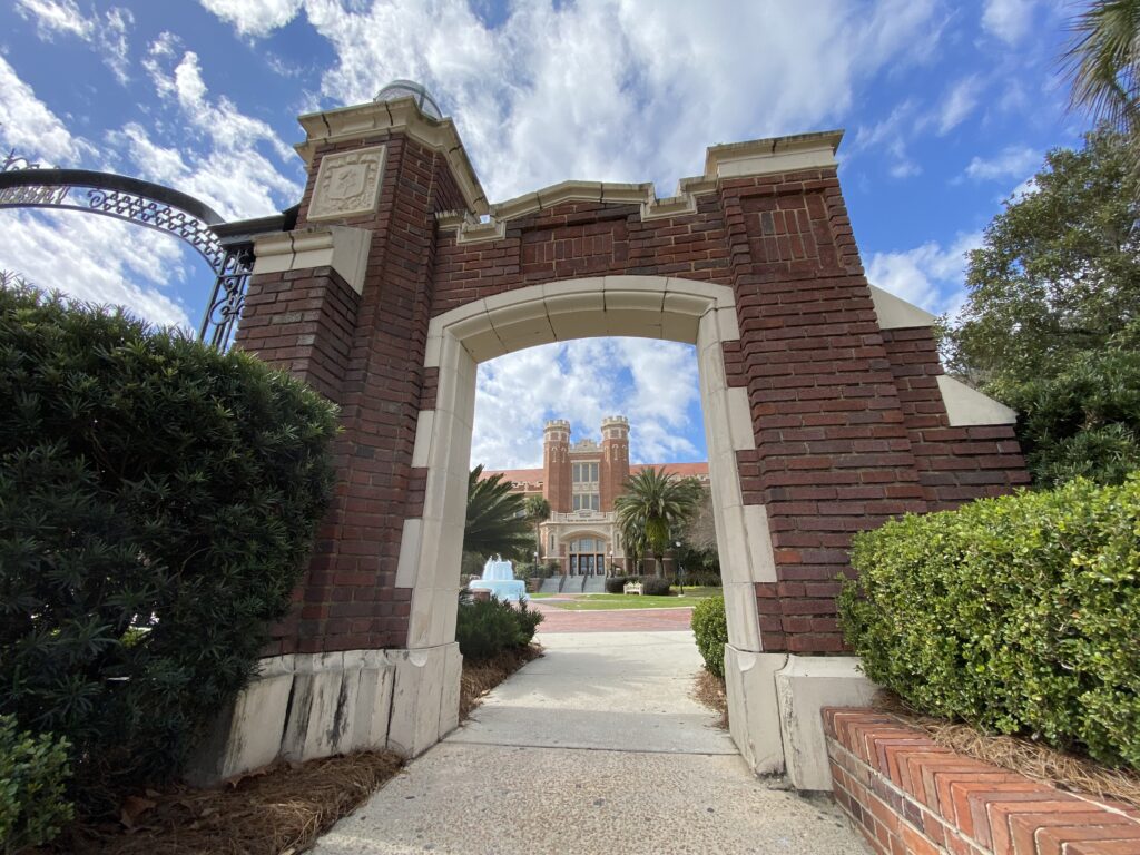 FSU Westcott 9 The entrance gate to the Westcott Building at FSU, with the building and fountain showing through the Entrance doorway on a sunny, blue sky day